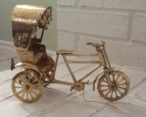 Miniature rickshaw made of brass.